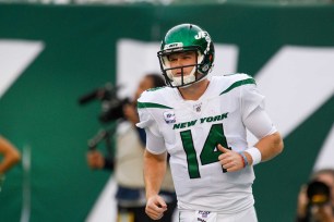 New York Jets quarterback Sam Darnold (14) jogs to the sideline