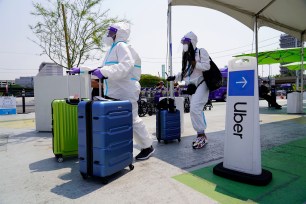 Passengers wait for an Uber ride at Los Angeles International Airport.