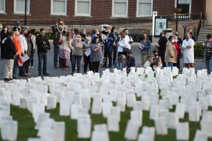 People visit a memorial for resident who died from COVID-19 outside the Reading Hospital in Pennsylvania.