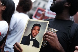 People participate in a protest to mark the five year anniversary of the death of Eric Garner