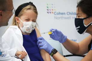 A child is vaccinated against COVID-19 at Cohen Children's Hospital in New Hide Park, NY.