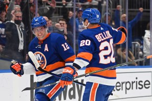 Josh Bailey (12) celebrates his power-play goal against the Devils.