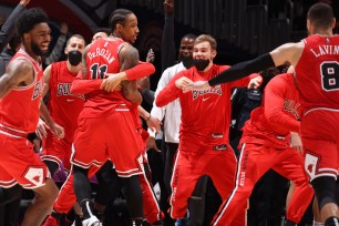 DeMar DeRozan is mobbed by teammates after his buzzer-beating jumper gave the Bulls a 120-119 win over the Wizards.