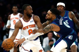 Knicks guard Kemba Walker looks to keep the ball away from Timberwolves' D'Angelo Russell during the first half.