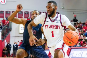 St. John's Red Storm forward Aaron Wheeler (1) drives past Fairleigh Dickinson Knights forward Daniel Rodriguez (25)