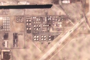 In this satellite image provided by Planet Labs PBC, white fire suppressing foam is seen after an attack on an Abu Dhabi National Oil Co. fuel depot in the Mussafah neighborhood of Abu Dhabi, United Arab Emirates, Monday, Jan. 17, 2022.