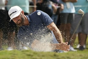 Dustin Johnson hits from a bunker on the third hole during the second round of the LIV Golf Team Championship at Trump National Doral Golf Club, Saturday, Oct. 29, 2022, in Doral, Fla.