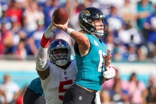 New York Giants defensive end Kayvon Thibodeaux (5) pressures Jacksonville Jaguars quarterback Trevor Lawrence (16) in the fourth quarter at TIAA Bank Field.