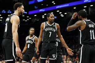 Kevin Durant #7 talks with Ben Simmons #10 and Kyrie Irving #11 of the Brooklyn Nets during the second half against the Dallas Mavericks at Barclays Center on October 27, 2022 in the Brooklyn borough of New York City.