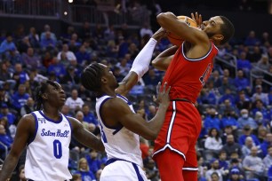 Joel Soriano #11 of the St. John's Red Storm is fouled by KC Ndefo #13 of the Seton Hall Pirates as Kadary Richmond #0 looks on during the first half of a game at Prudential Center on December 31, 2022 in Newark, New Jersey. Seton Hall defeated St. Johns 88-66.