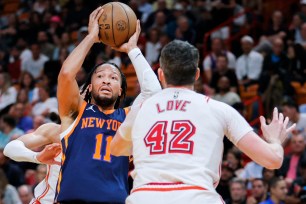 Jalen Brunson, looking to make a move on Kevin Love during a recent Knicks' loss to the heat, is questionable for Wednesday's home game against Miami.