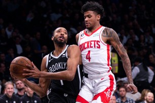 Mikal Bridges, who scored 27 points, drives around Jalen Green during the Nets' 123-114 win over the Rockets.