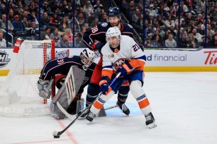 Kyle Palmieri skates against Boone Jenner as Blue Jackers goalie Michael Hutchinson defends.