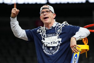 Dan Hurley reacts after cutting down the net following a victory against the Gonzaga Bulldogs, earning them a spot in the Final Four.