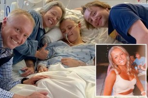 University of Georgia student Liza Burke lying in bed surrounded by her family