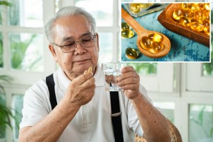 Senior Asian man with cup of water and pill looking at camera and taking remedy in cozy room at home. Old male taking medicine.