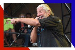 Marshall Tucker Band singer Doug Gray points to the crowd emphatically with the microphone in hand.