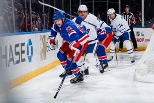 Adam Fox #23 of the New York Rangers skates with the puck against the Toronto Maple Leafs