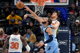 Knicks center Isaiah Hartenstein, right, blocks a shot by Memphis Grizzlies forward David Roddy (21) during the first half on Saturday.