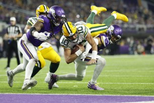 Jordan Love runs for a touchdown against the Vikings.