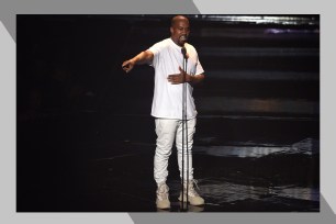 Kanye West points to the audience from the stage.