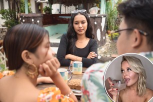 Person with folded arms looking on awkwardly as they wait to join a conversation with a couple, depicting the concept of a third wheel