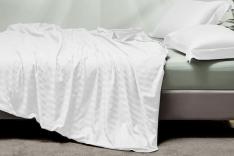 A bed with a white blanket