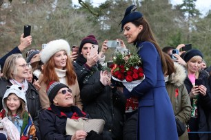 Kate Middleton talks to crowds while holding a bunch of roses