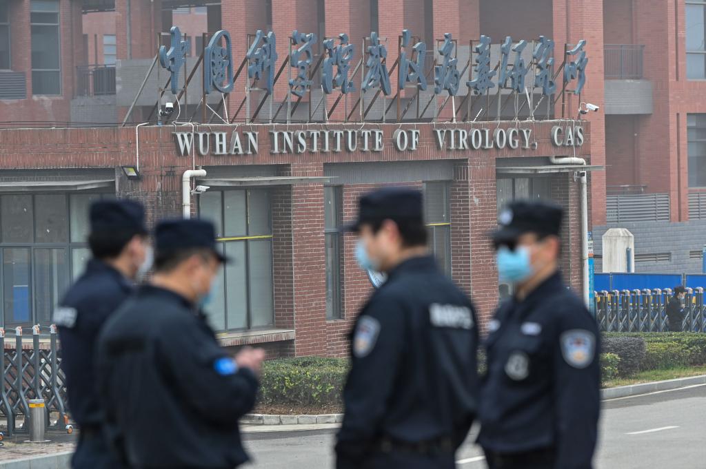 Security personnel stand guard outside the Wuhan Institute of Virology in Wuhan as members of the World Health Organization (WHO) team investigating the origins of the COVID-19 coronavirus make a visit to the institute in Wuhan in China's central Hubei province on February 3, 2021.