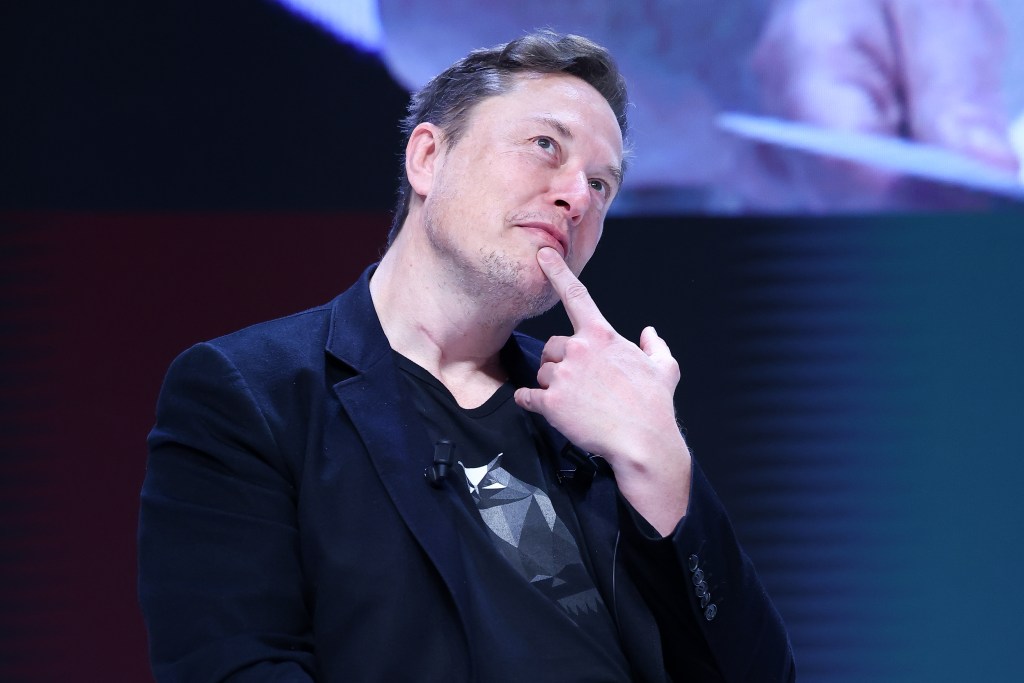 Elon Musk in a suit attending the 'Exploring the New Frontiers of Innovation' session at Cannes Lions International Festival Of Creativity 2024