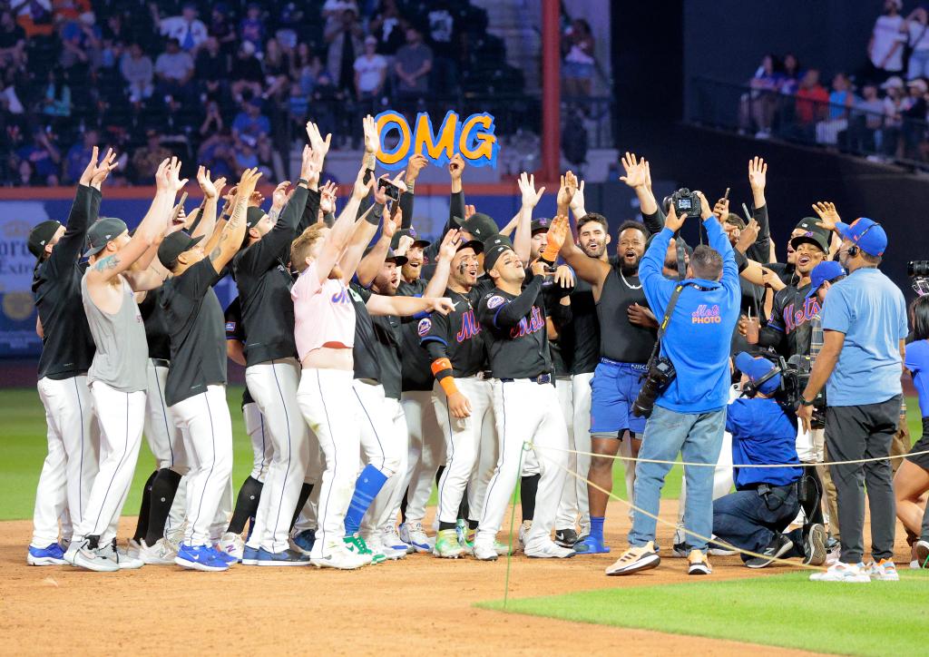 New York Mets second baseman Jose Iglesias #11 singing his hit song 'OMG' on the field surrounded by his teammates after winning against Houston Astros at Citi Field