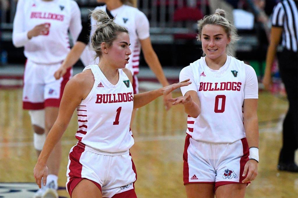 Fresno State's Haley Cavinder, left, and Hanna Cavinder celebrate during the team's NCAA college basketball game game against Boise State