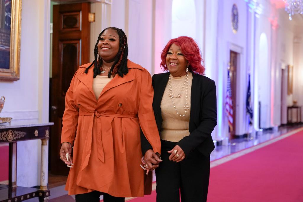 Presidential Citizens Medal honorees Shaye Moss, a former Georgia election worker, left, and her mother Ruby Freeman arrive in the East Room of the White House in Washington, Friday, Jan. 6, 2023, for a ceremony to mark the second anniversary of the Jan. 6 assault on the Capitol and to award Presidential Citizens Medals