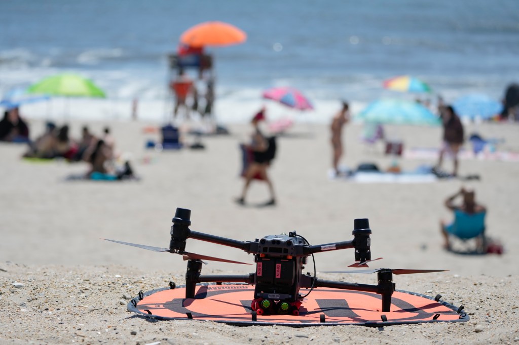 A drone with emergency flotation devices attached prepares to launch at Rockaway Beach in New York, Thursday, July 11, 2024