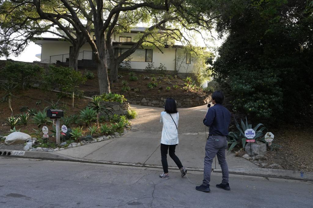 Fuji TV media members stand outside a mansion house purchased by Los Angeles Dodgers player Shohei Ohtani.