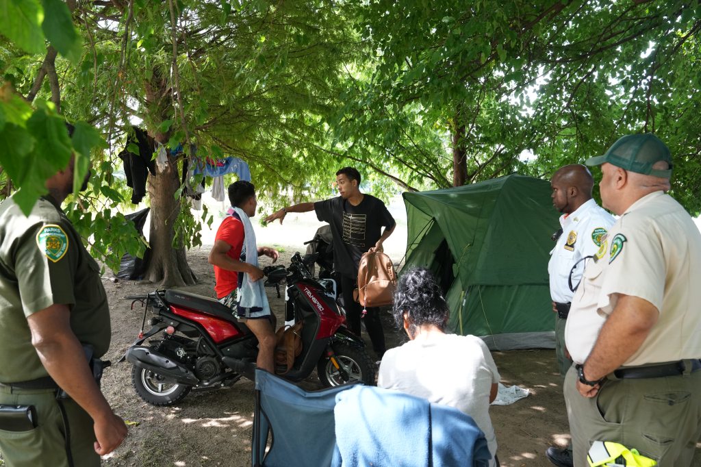 Members of the New York City Police Department and Parks Enforcement Patrol clear a migrant encampment on Randalls Island on Friday.