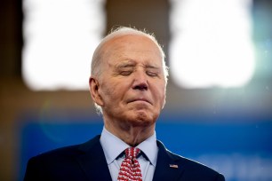 U.S. President Joe Biden standing on stage as Vice President Kamala Harris introduces him at a campaign rally at Girard College in Philadelphia, Pennsylvania.