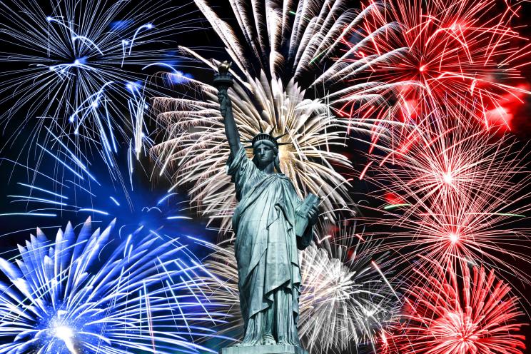 Statue of Liberty, blue white and red fireworks July 4th celebration in New York