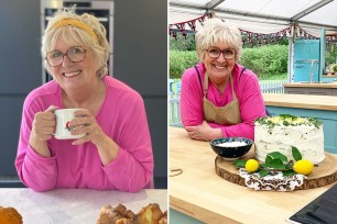 A woman in a pink shirt holding a white mug with a cake