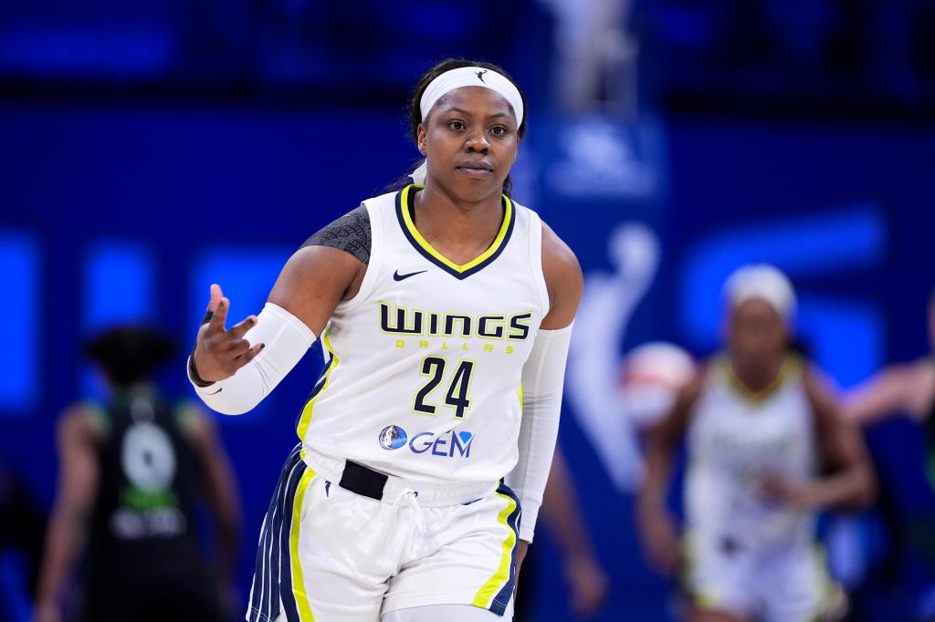 Dallas Wings guard Arike Ogunbowale (24) celebrates after sinking a three-point shot against the Minnesota Lynx in the second half of a WNBA basketball game in Arlington, Texas, Thursday, June 27, 2024.  