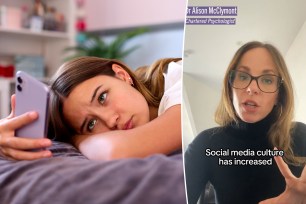 Depressed teenage girl lying on her bed at home, looking at her mobile phone