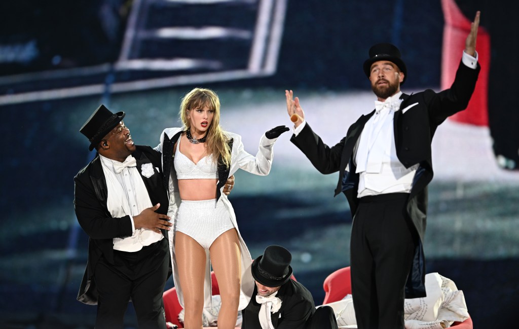 Taylor Swift is joined on stage by Travis Kelce (R), during "Taylor Swift | The Eras Tour" at Wembley Stadium on June 23, 2024 in London, England.  