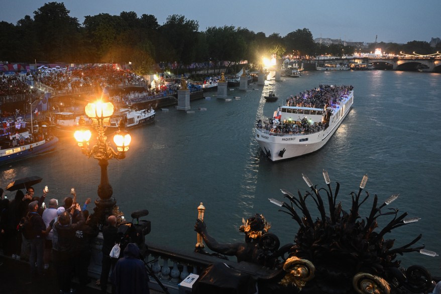 France's delegation sail in a boat along the river Seine.