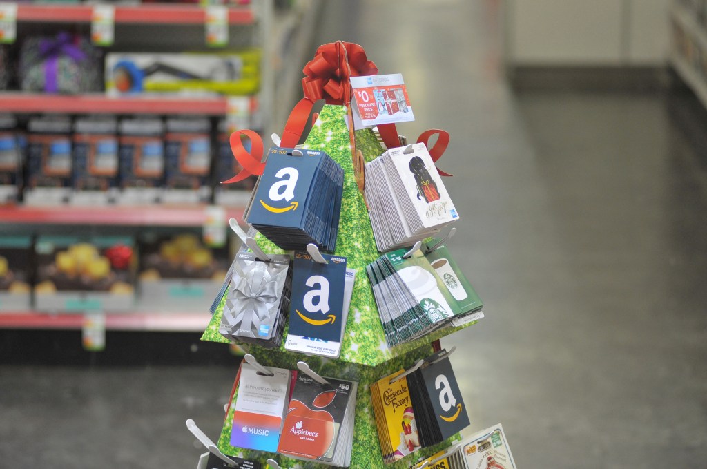 Gift cards on a carboard tree in a pharmacy.