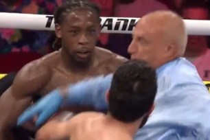 The referee gets hit in the face by Miguel Madueno (front) a the end of the sixth round of his 10-round loss to Keyshawn Davis, who stared back at Madueno.