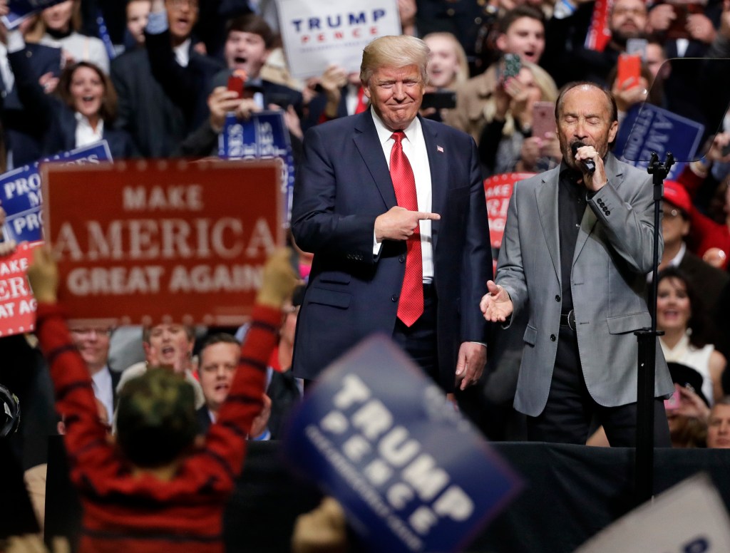 Greenwood singing "God Bless the USA" on stage with then-President Donald Trump at a rally in Nashville on March 15, 2017.