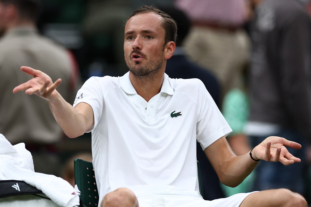 Russia's Daniil Medvedev gestures to his coach as he reacts after losing the first set to France's Alexandre Muller during their men's singles second round tennis match on the third day of the 2024 Wimbledon Championships