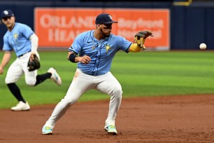 The Rays Issac Paredes throwing from third base.