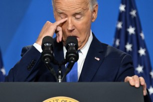 US President Joe Biden wipes his eye as he speaks during press conference