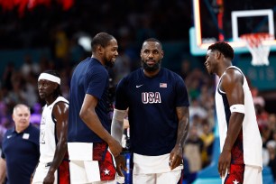 (From L.) Kevin Durant, LeBron James and Anthony Edwards celebrate after Team USA's Olympic win over South Sudan on July 31, 2024. 